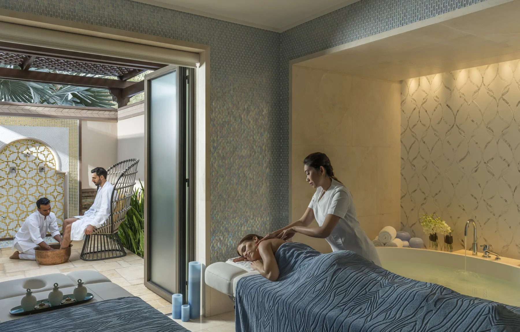 Pearl Spa treatment room with a massage in progress and an outdoor foot ritual