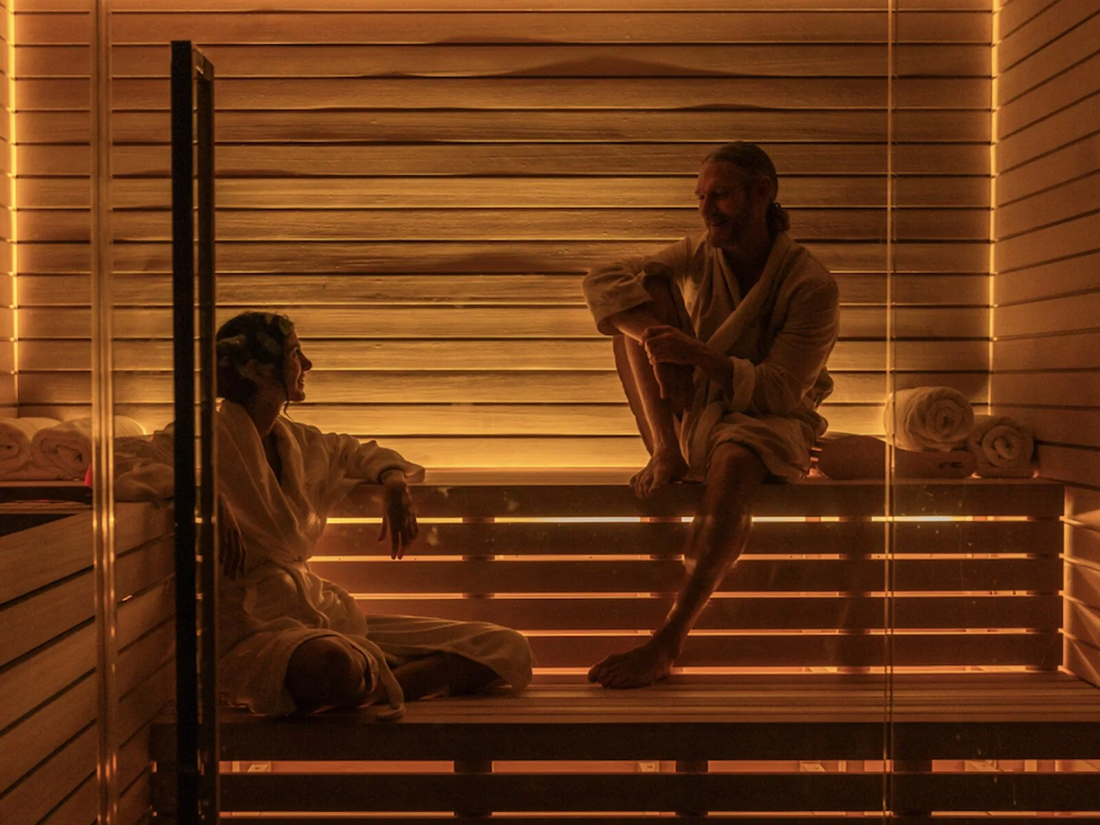 Two guests in robes inside the sauna at Virgin Hotels New York
